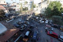 A view shows an area of Al-Ahli hospital following the blast. Burnt out cars can be seen in the foreground