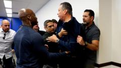Moment security drags US senator out of Noem LA press briefing