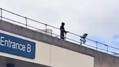 Man who scaled hospital roof wearing black gown and 'plague' mask fined