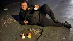 Taxi driver floats rubber ducks in pothole protest