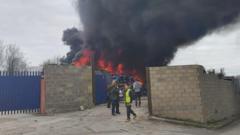 Huge fire rages at scrapyard as explosions reported