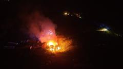 Explosions wake residents as fire destroys barns