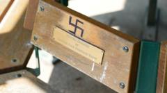 Police investigate swastikas on park benches