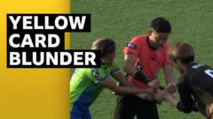 Referee needs help from players when yellow card gets stuck