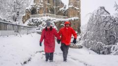 Snow brings travel disruption as amber warning extended into Monday