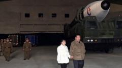 Kim Jong-un stood hand-in-hand with the girl and posed for photos at a ballistic missile launch
