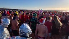 Hundreds gather to celebrate 60 years of Christmas Day dip