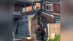 The man who balances bikes, ladders and sheds on his chin