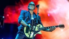 What Tensions Did Def Leppard's Guitarist Reveal About Onstage Struggles?