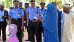 Di woman and her six year old pikin as Police Commissioner dey tok to her