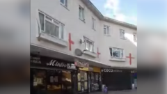 Racist abuse arrest after flags painted on homes