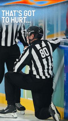 Ice hockey referee gets puck to the ribs