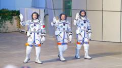 Chinese astronauts Zhang Lu (C), Wu Fei (R) and Zhang Hongzhang (L) at their send-off ceremony in October 2025.