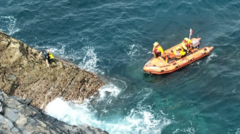 Dad and teenage son rescued after kayaks drift