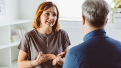 A worried woman talking with a psychotherapist in an office