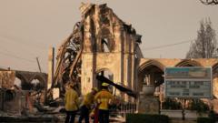 LA crews race to halt wildfires ahead of high winds