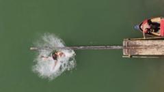 Competitors take on greasy pole challenge