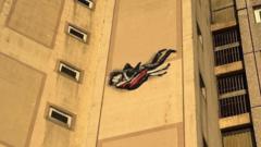 Street artist investigated over 'distressing' mural on listed flats