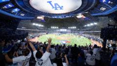 Inside a Cosm venue showing fans of the LA dodgers celebrating the 2025 World Series win. The screen shows a giant view of the pitch.