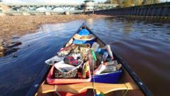 Paddle volunteers sink oars into river cleanup