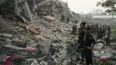 Rescuers search for survivors trapped in the collapsed Sky Villa Condominium building in Mandalay