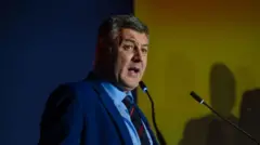 Byrne speaking into a mic