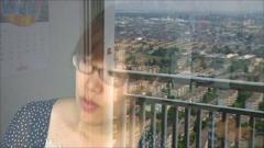 Emiko Yamamoto looks out from the 30th floor