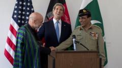 Afghan President Hamid Karzai, US Secretary of State John Kerry and Pakistani military chief General Kayani following talks in Brussels
