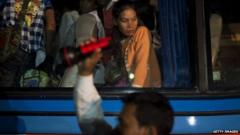A Cambodia woman waits to get off a bus after crossing the Thai border on June 17, 2014 in Poipet