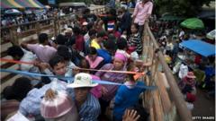 Cambodian workers wait inside a truck to take them to their home after crossing the Thai border on June 17, 2014 in Poipet