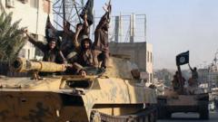 Islamic State fighters drive armoured vehicles through Raqqa, Syria (30 June 2014)