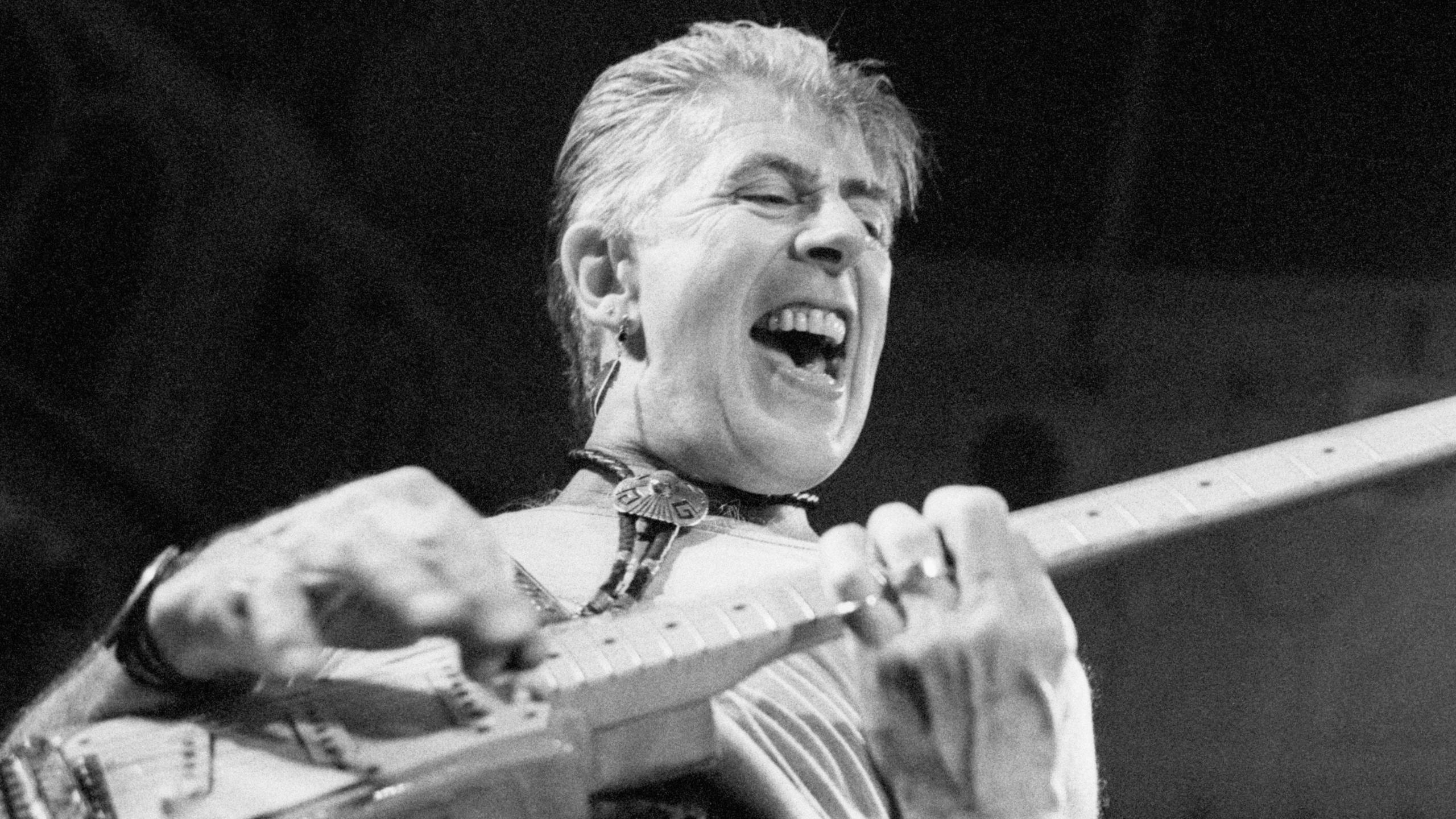 John Mayall looking excited while playing guitar