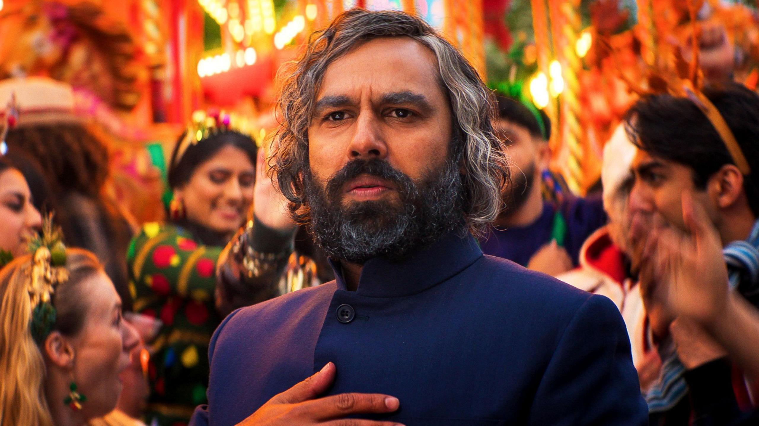 Kunal Nayyar as a contemporary Scrooge, called Mr Sood, in a scene from Christmas Karma