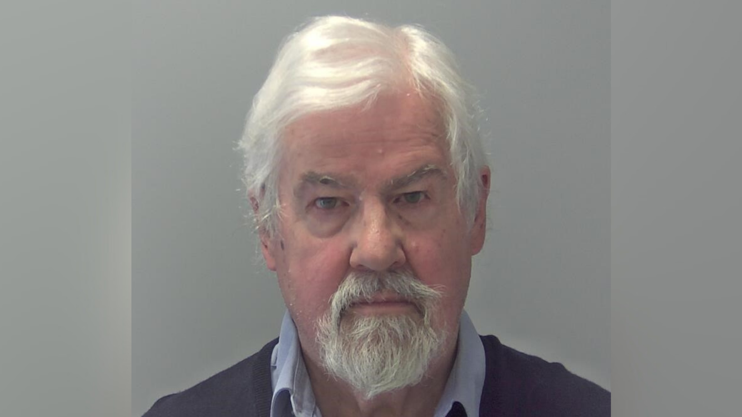 A mugshot image of Martin Hogg. He is looking directly into the camera and standing against a grey backdrop.