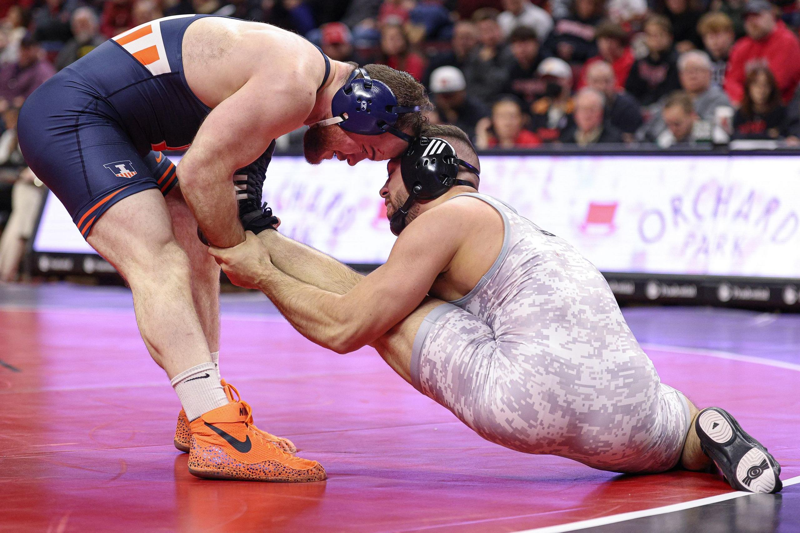 John Poznanski of the Rutgers Scarlet Knights wrestles Zac Braunagel of the Illinois Fighting Illini in the 197-pound match during a meet at Jersey Mike's Arena in Piscataway, New Jersey