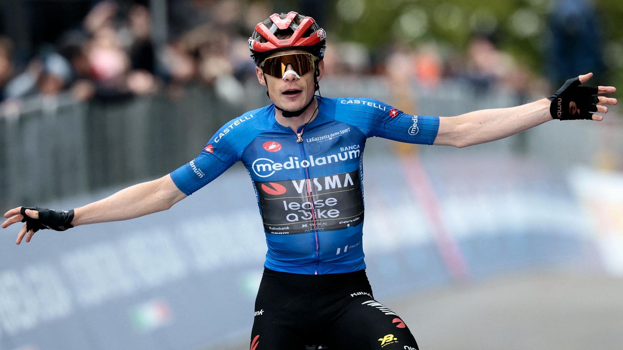 Jonas Vingegaard spreads his arms out as he celebrates winning stage nine of the Giro d'Italia