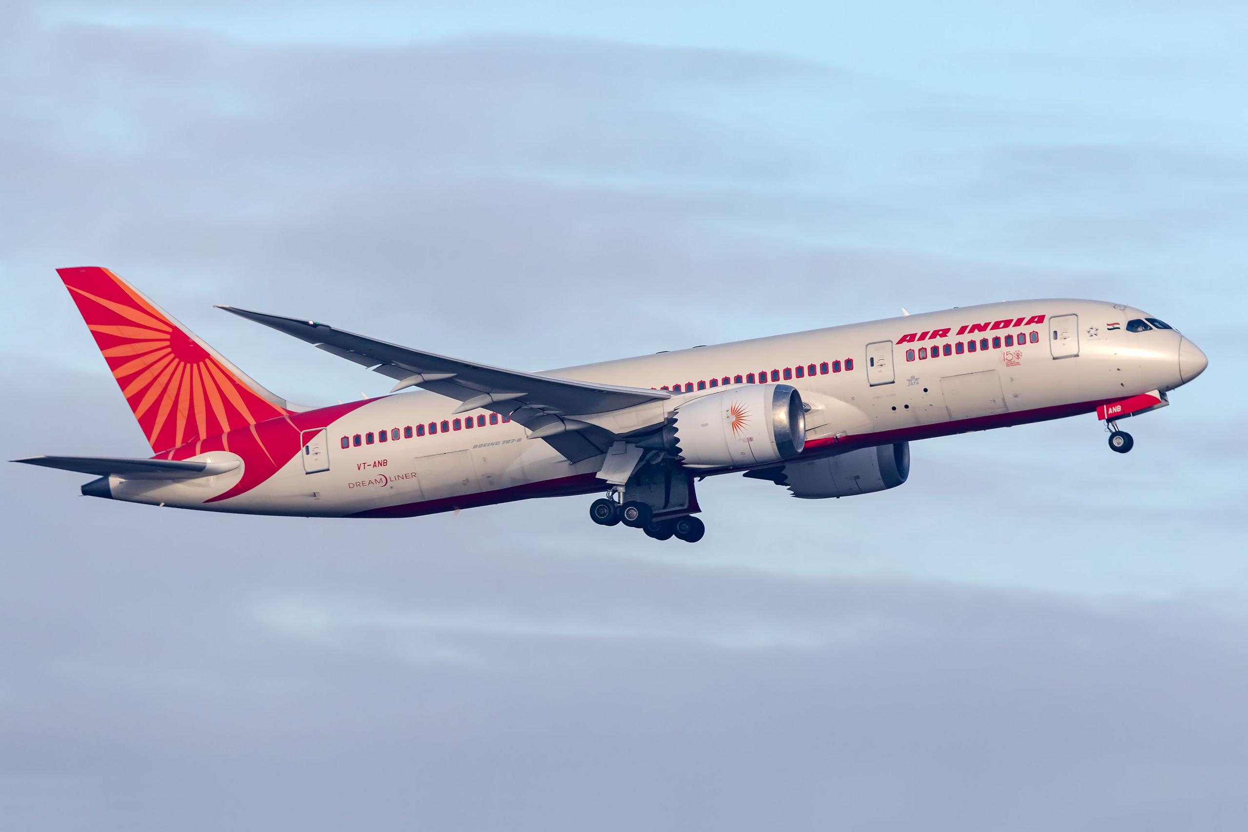 a boeing 787-8 dreamliner taking off with air india branding
