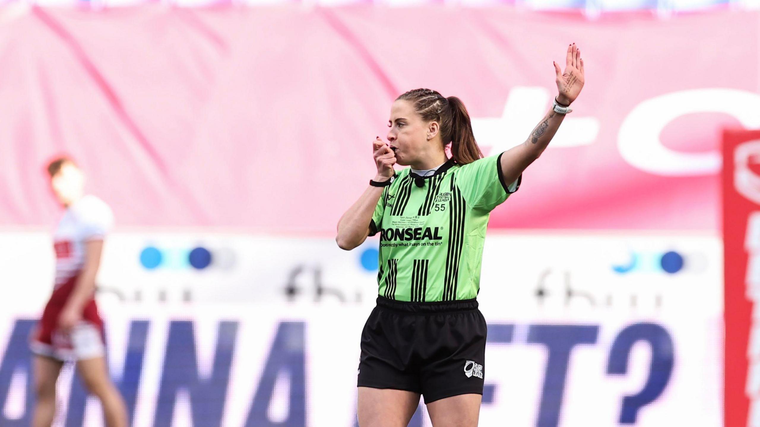 Tara Jones stood with the whistle in her mouth and her left hand raised high