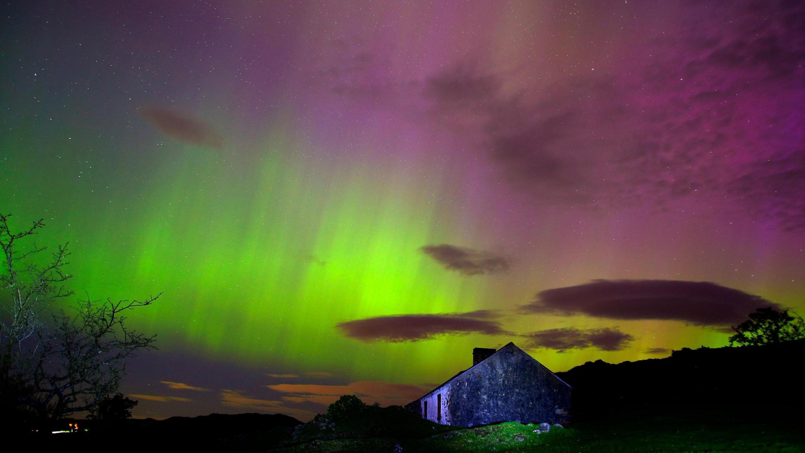 Northern Lights over a green building