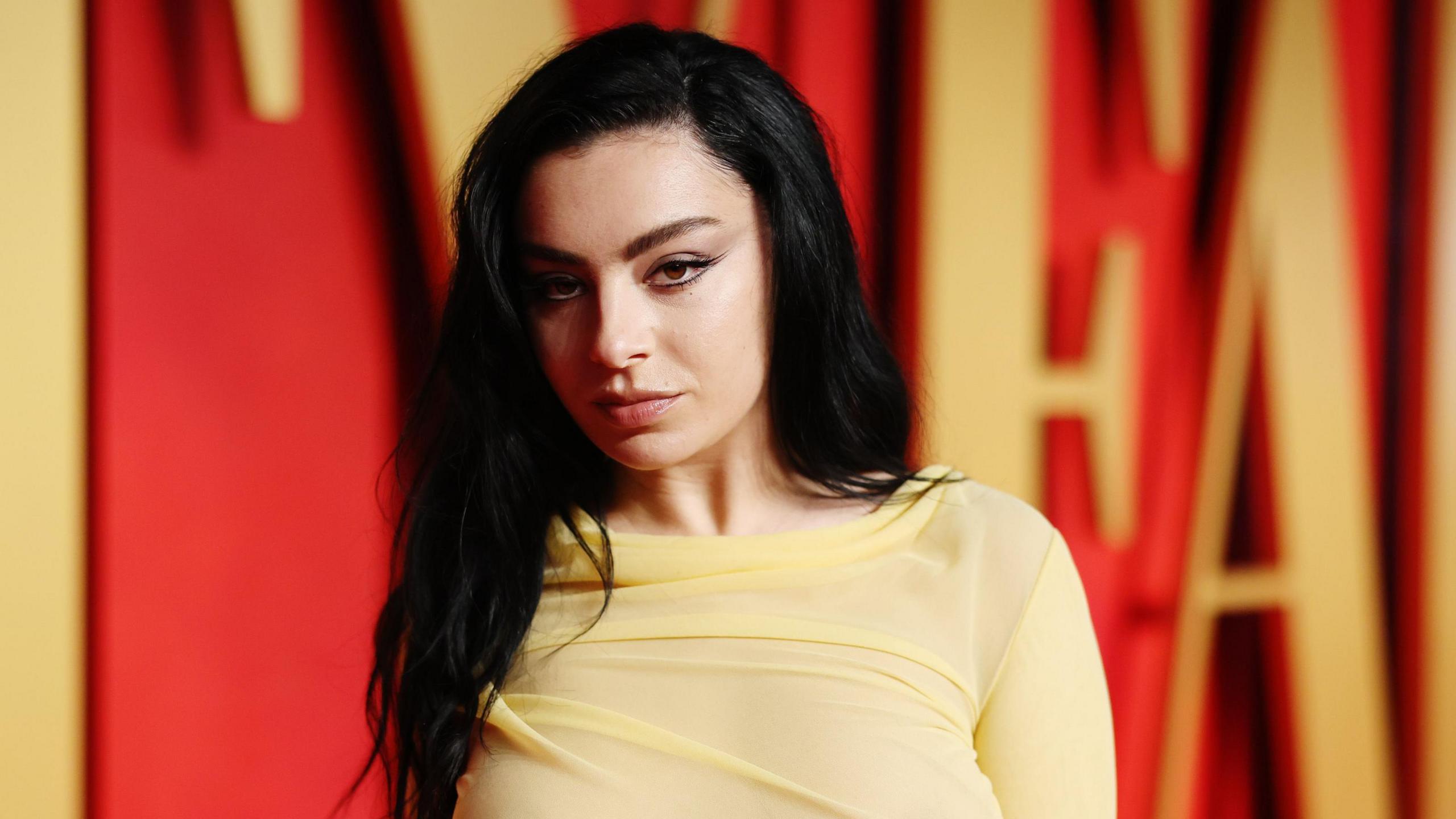 Charlie XCX wearing a yellow dress