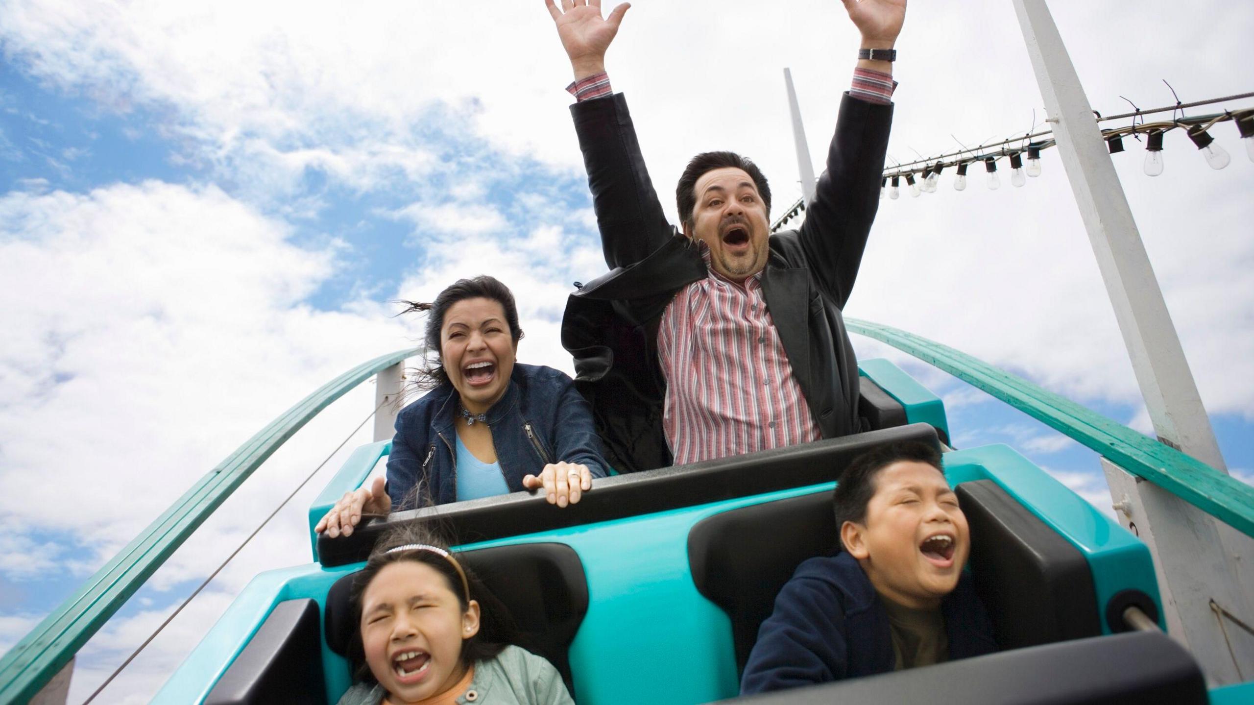 A stock image of a family enjoying a rollercoaster. 