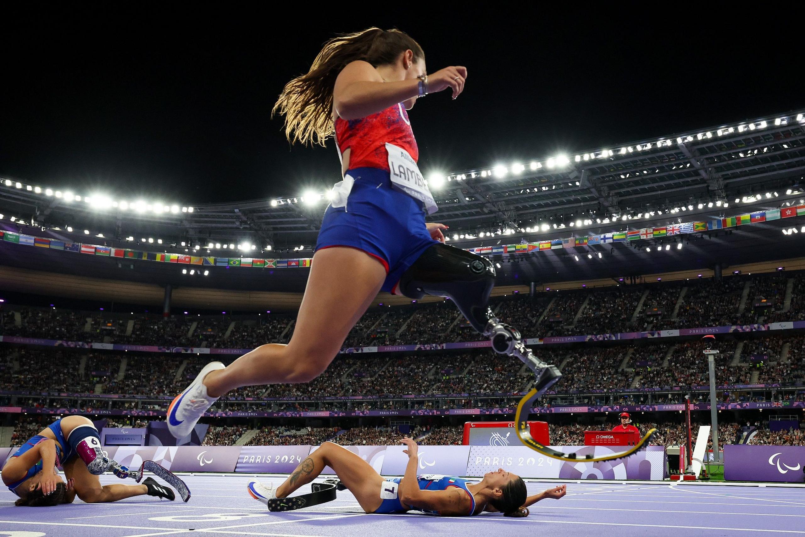 Noelle Lambert competes in the women's 100m T63 final as Ambra Sabatini and Monica Contrafatto fall just before the finish line