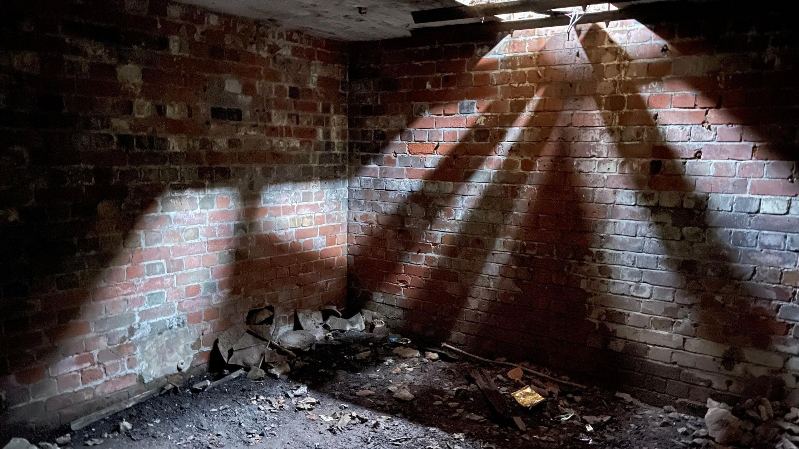 An empty room with natural light coming through the roof