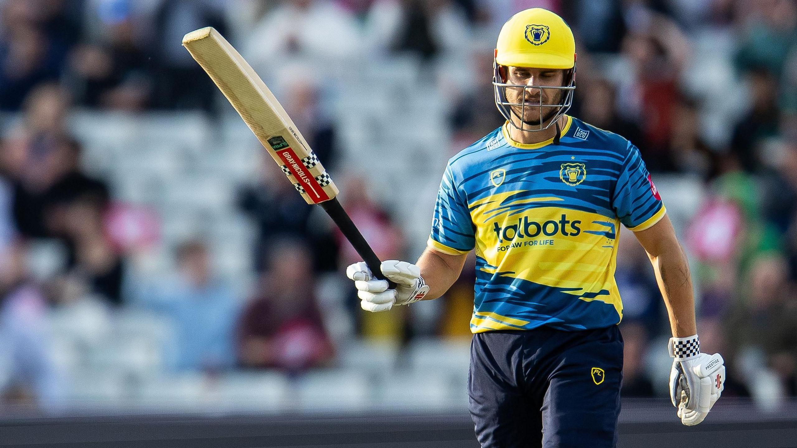 Sam Hain raises his bat to the crowd after scoring a half-century in the T20 Blast for Birmingham Bears