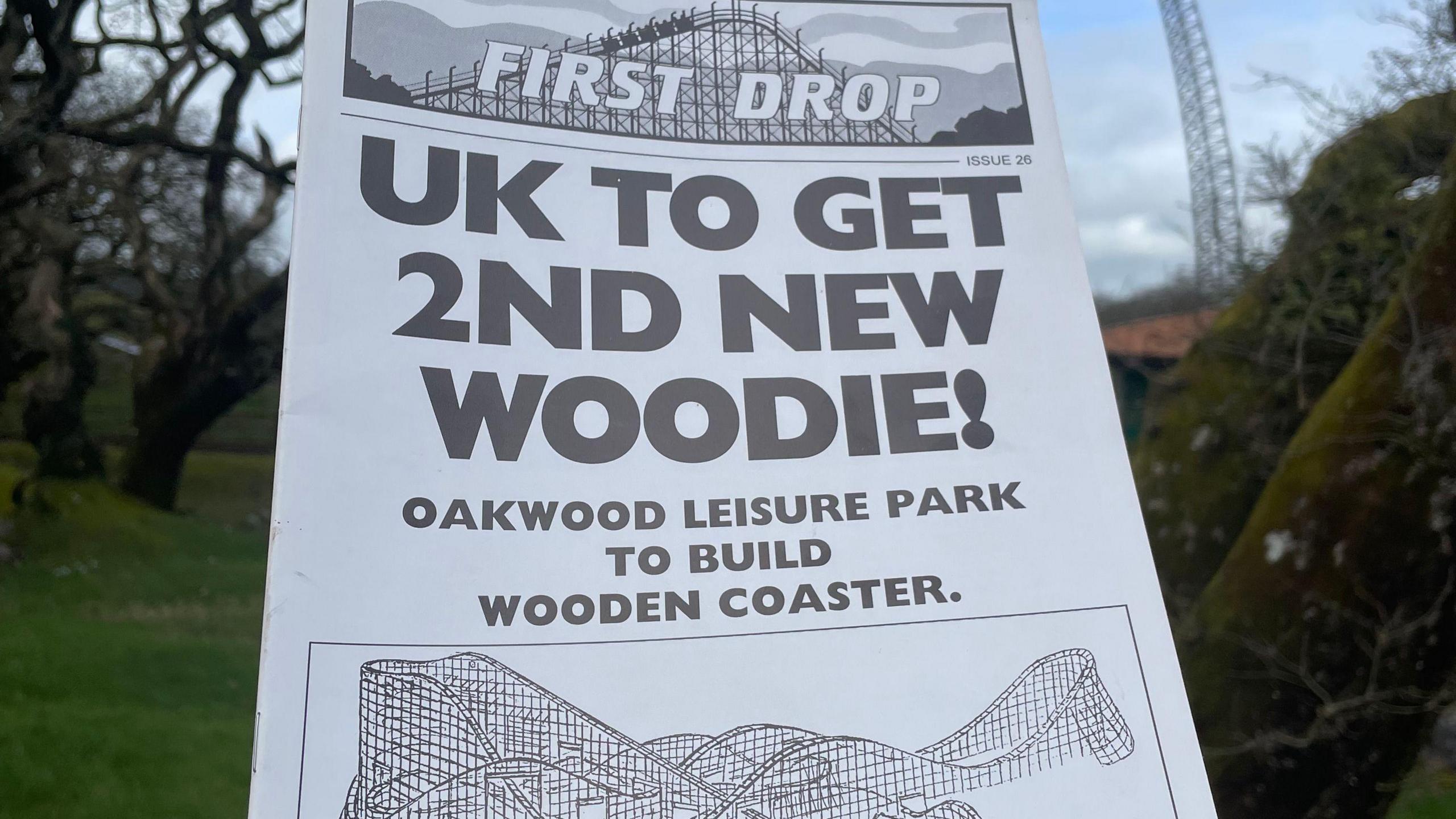 The front cover of the magazine First Drop published at the time when Megafobia was being built. The headline reads 'UK to get 2nd new woodie! Oakwood leisure park to build wooden rollercoaster'. Below is a black and white sketch of Megafobia. 