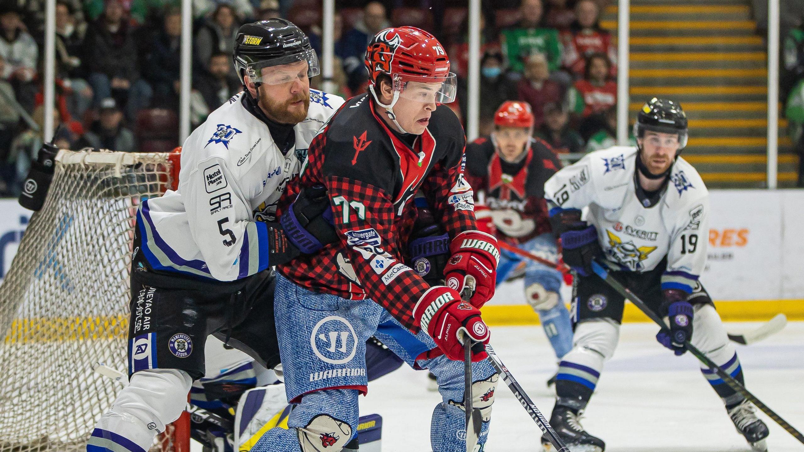 A Cardiff Devils player battling a Manchester Storm player.