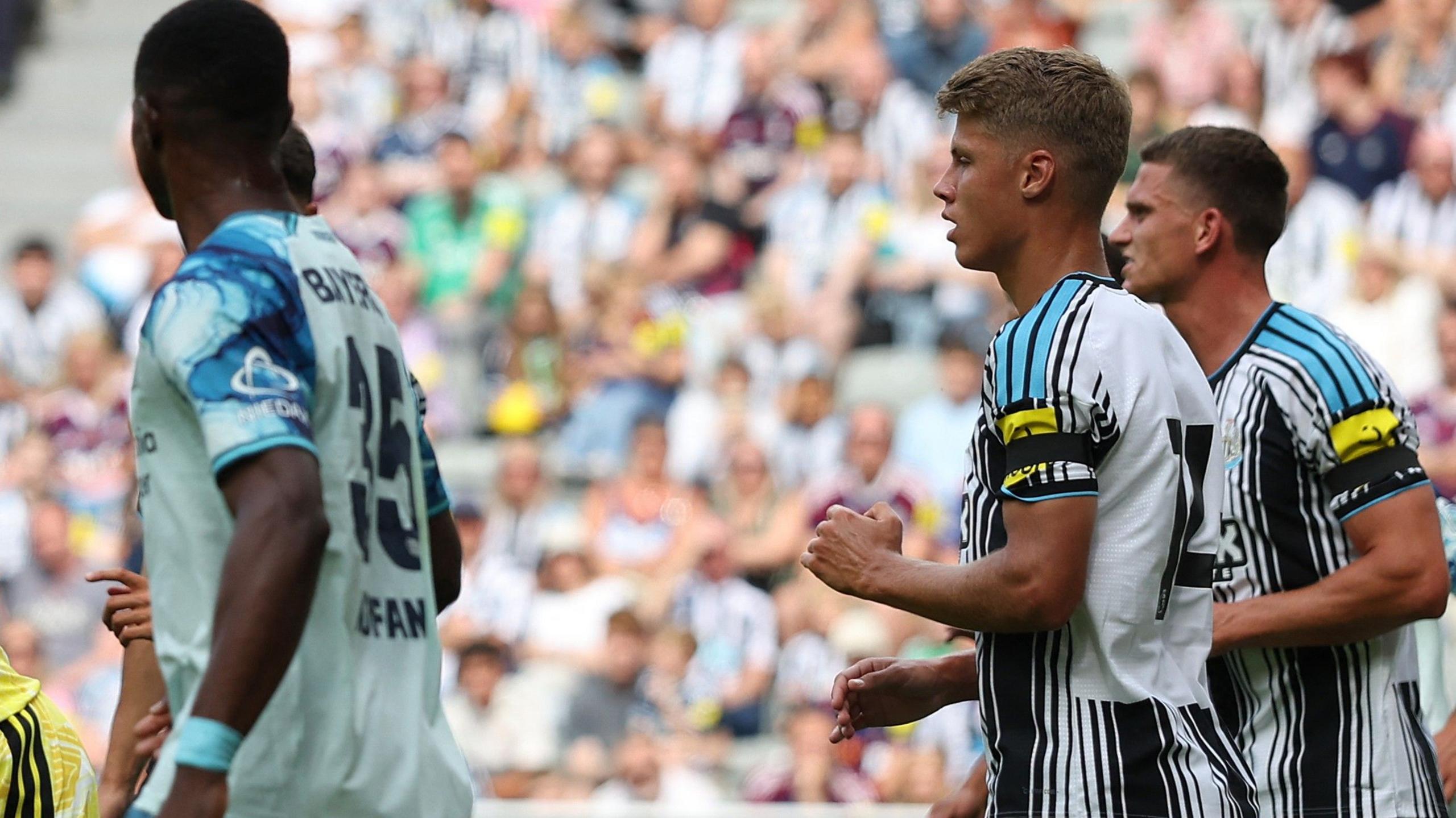 A general image showing Newcastle players and a Bayer Leverkusen player during their friendly match.
