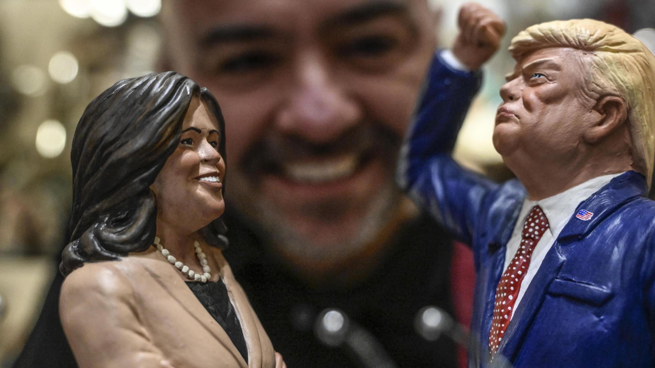 Genny Di Virgilio, a nativity scene artisan from San Gregorio Armeno, looks at his terracotta figurines of US Vice President Kamala Harris and Republican Presidential candidate Donald Trump, ahead of the US presidencial election in Naples, Italy, 02 November 2024.