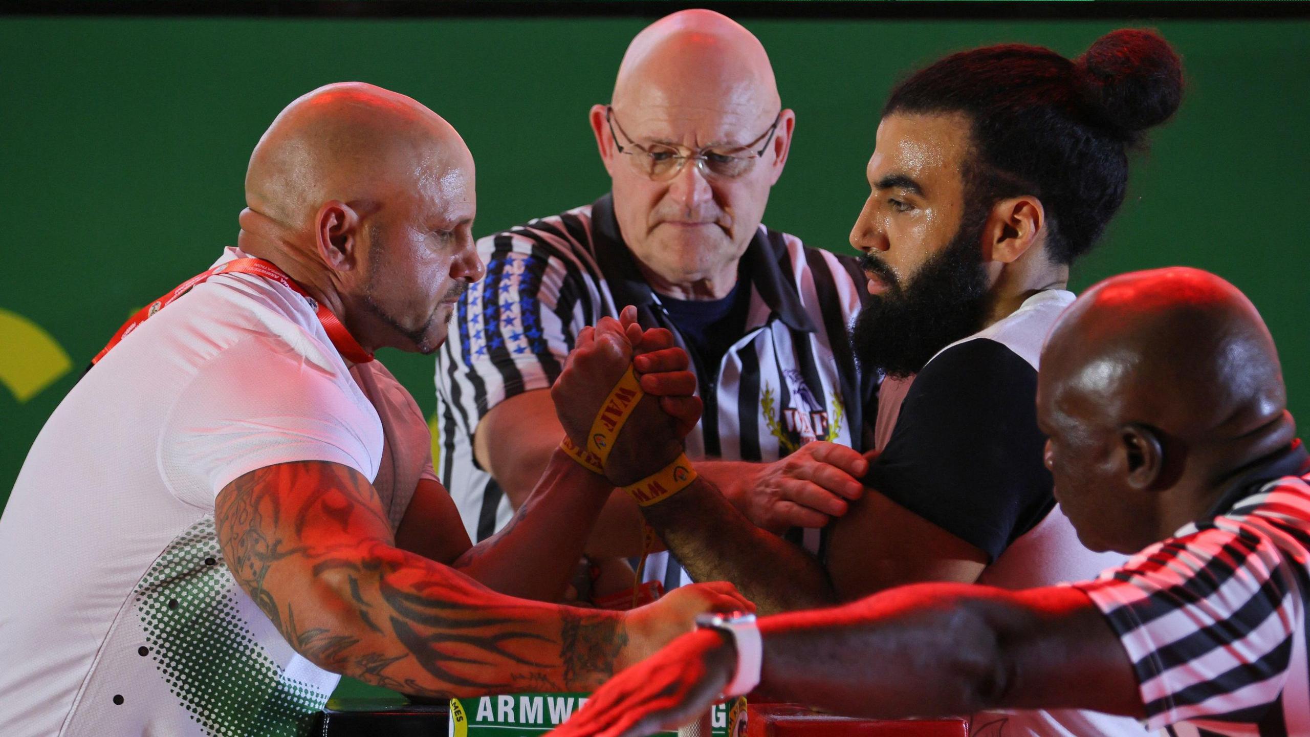 South Africa's James Kruger (left) competes against Egypt's Mustafa Mohamed (right) in the senior men's left arm wrestling competition during the 2023 African Games in Accra, Ghana.