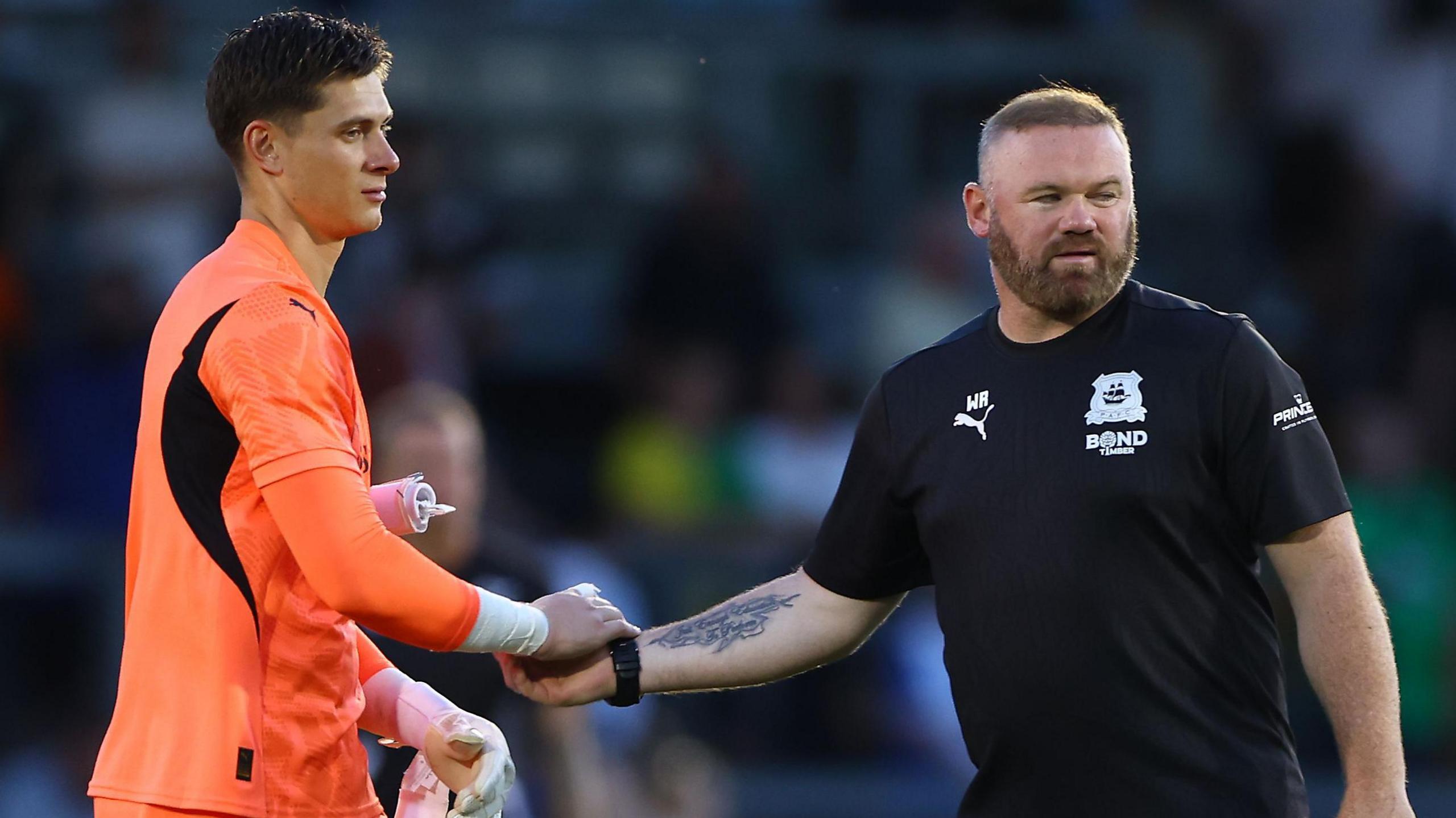 Wayne Rooney shakes Michael Cooper's hand.